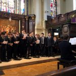 group of boys in suits, singing in Church at Christmas concert
