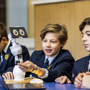 students looking at a robot, made with an iPhone presenting eyes