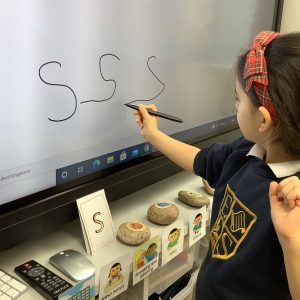 child drawing a smart board
