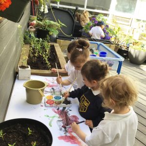 children painting outside
