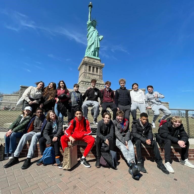 students stood outside the Statue of Liberty