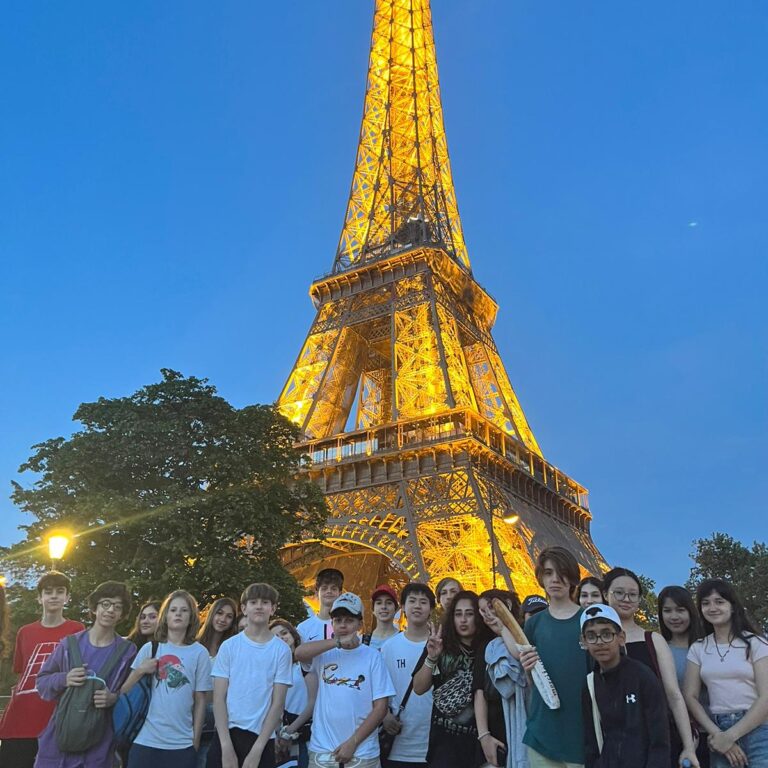 students standing by the Eiffel tower